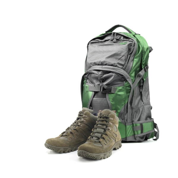 isolated image of a green backpack and brown hiking boots with white background