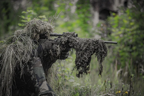 sniper wearing ghillie with matching gun wrap