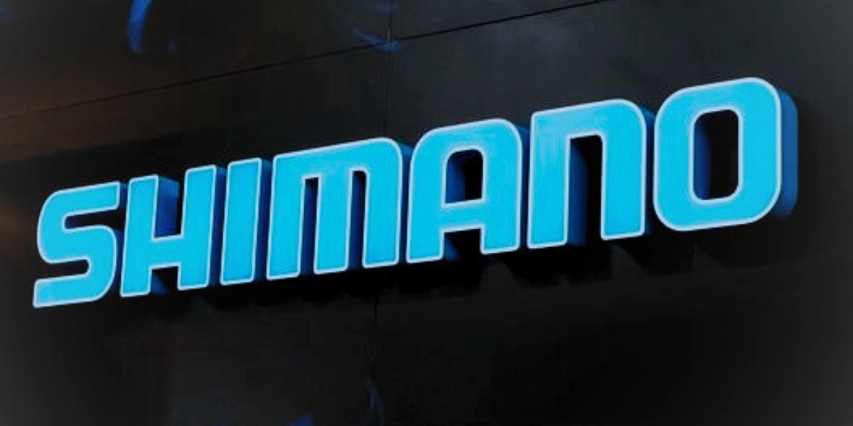 bright blue lettering spelling of Shimano on dark background