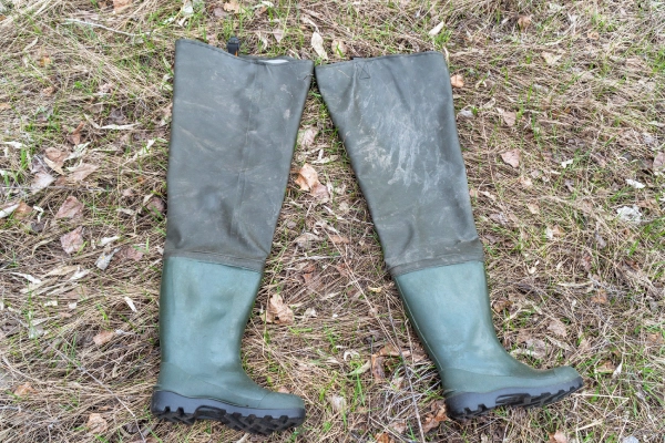 photo of green wading boots layer on the grass