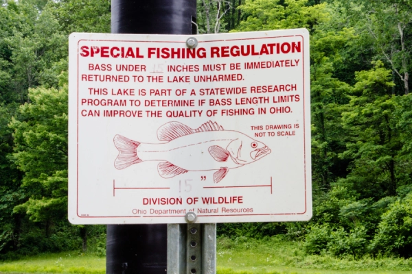 photo of a red and white sign displaying local fishing rules