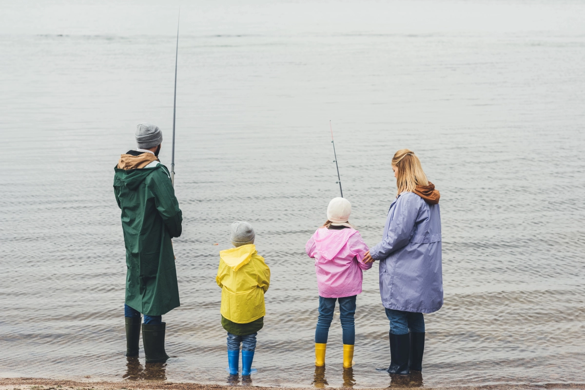 back view of a family fishing together